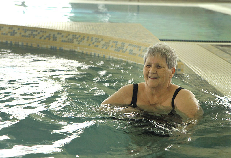 Margaret walks in the lazy river, a good prehabilitation for elective surgeries according to the Impact Clinic.