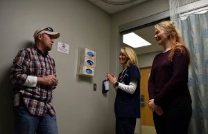 Keith talks with his urgent care doctor and nurse to thank them months after her was diagnosed with colon cancer that that urgent care.