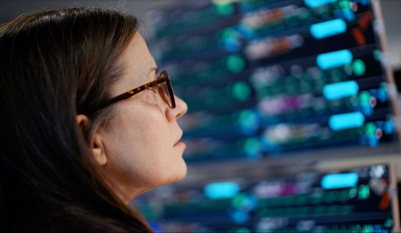 lady monitors screens at UCHealth Virtual Health Center