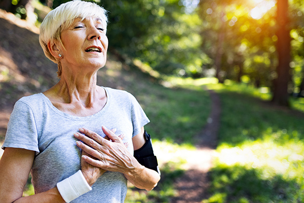 Older woman holding chest