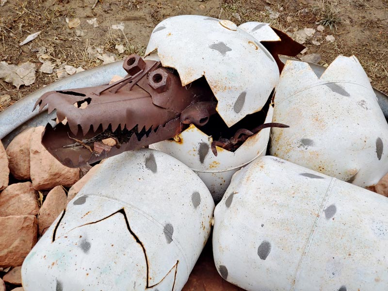 propane tanks painted as eggs with a metal creature coming out of one.