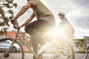 couple riding bike as getting exercise and being outdoors is on the list of ideas for social distancing.