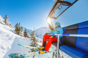 man on a chirlift, who can't ski anymore because of the outbreak of coronavirus at colorado ski areas closed them down.