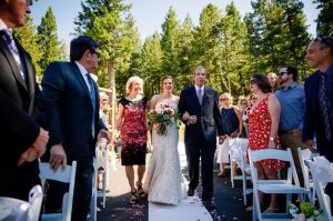Dr. Michael Douglas and his wife, Meg, walk their daughter down the aisle at her wedding. Michael is the first patient in Colorado to have received convalescent plasma to help fight COVID-19.