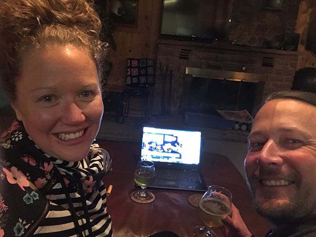 couple selfie of them watching live concert on their computer, one of the ways people are connecting during covid pandemic.