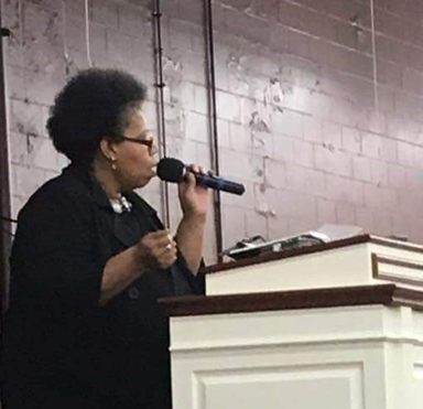 African American COVID-19 survivor Ravi Turman is a minister. Here, she speaks at her former congregation in Indiana.