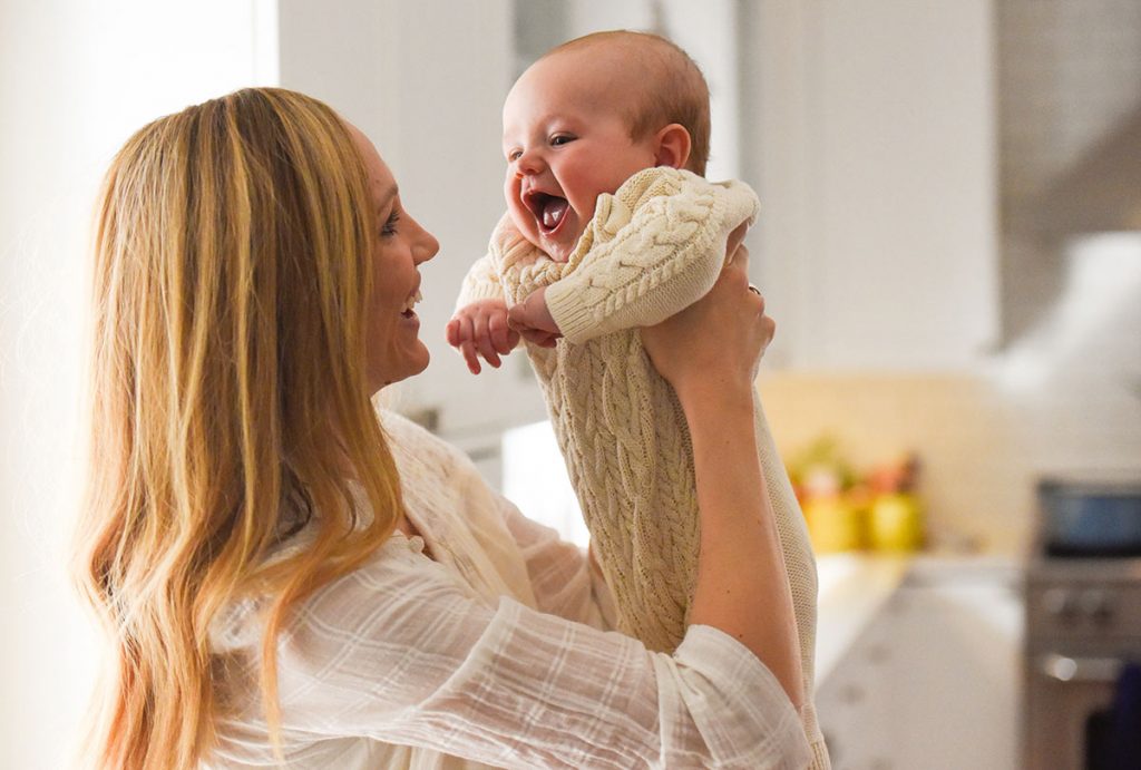 Jenny York holds up her new baby, Hudson.