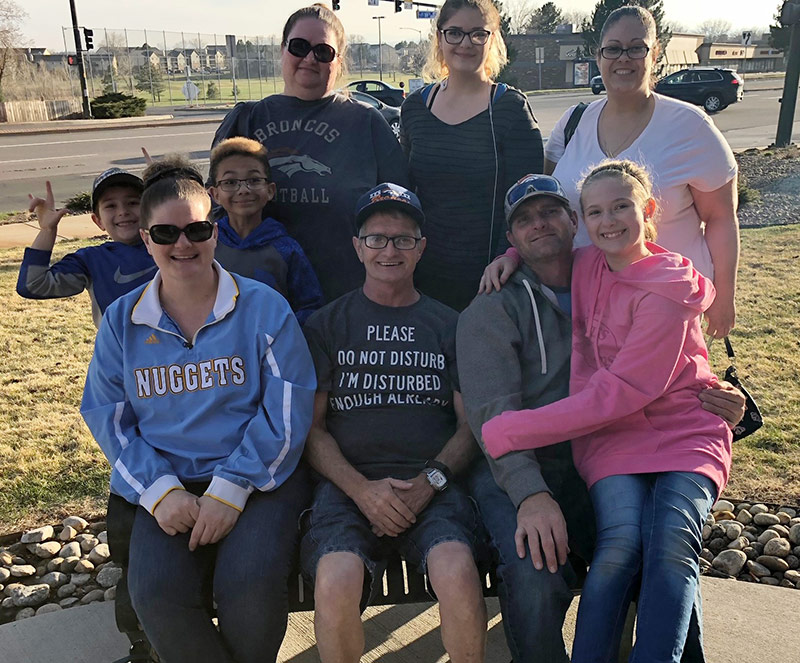 family stands together at a park after grandpa went from a LVAD to a heart transplant in order to return to his life.
