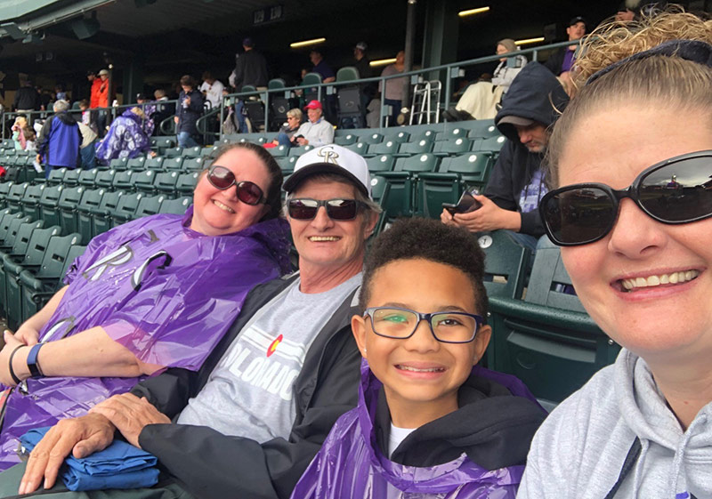family takes a selfie at a rockies game after Cliff went from a LVAD to a heart transplant and was feeling better.