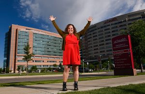 Dr. Michelle Barron, the top infectious disease expert in Colorado. Here, she holds her arms up in front of UCHealth University of Colorado Hospital.