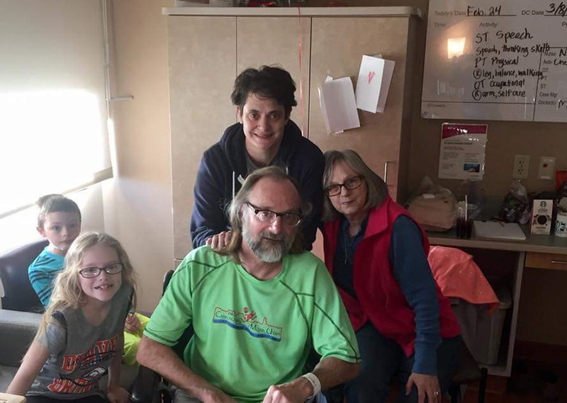 Jeff with his wife and grandchildren in the hospital during his hemorrhagic stroke treatment.
