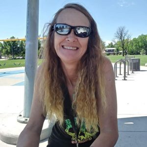 Pamela at a park, smiling, after having had rreteral reconstruction.