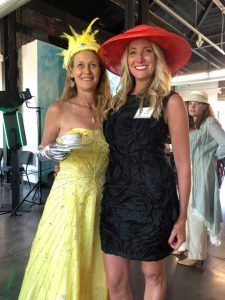 two women dress up at a fundraiser event.