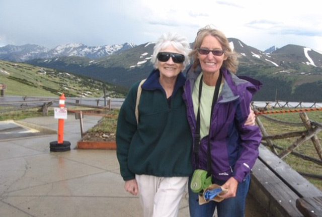 Claire with a friend at a mountain trailhead.