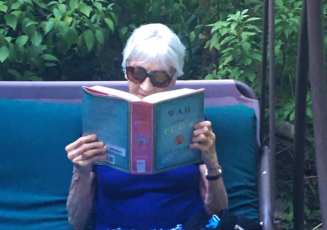 Claire, after TAVR addressed her severe aortic stenosis, enjoying War and Peace during the coronavirus pandemic.
