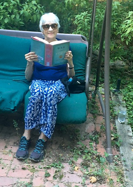 Claire, after TAVR addressed her severe aortic stenosis, enjoying War and Peace during the coronavirus pandemic.