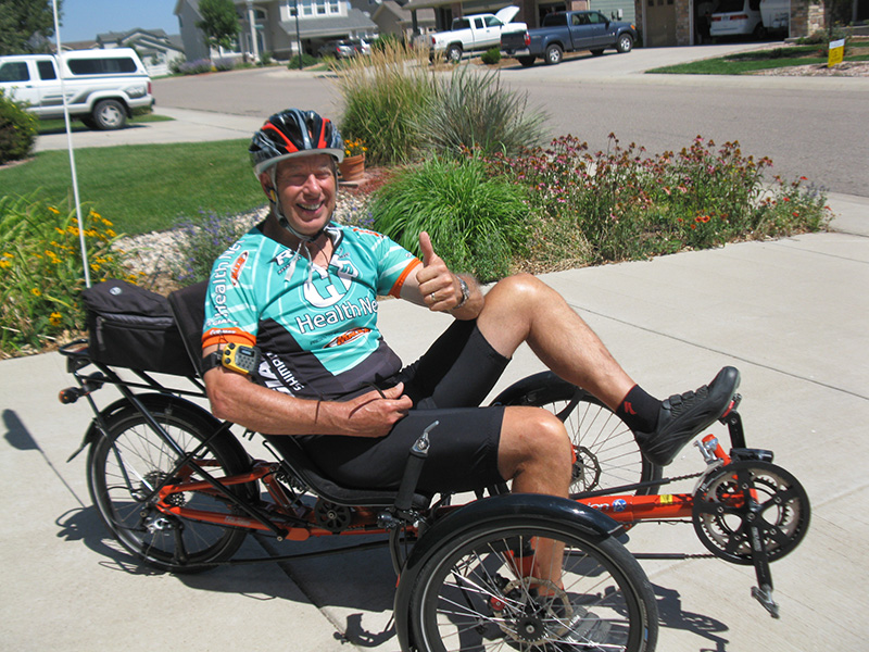 Dave on his trike giving a thumbs up. getting out to do something you enjoy is one tool for caregivers.