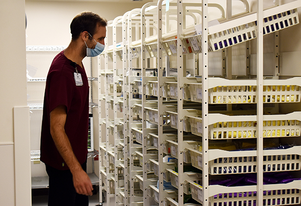 Nurse assistant looks for supplies in supply room in the newly renovated wing at PVH.
