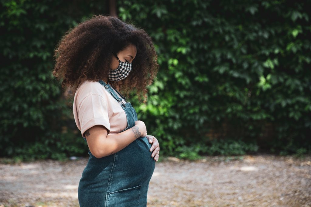 A pregnant woman admires her growing stomach in this photo.