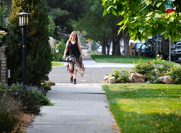 Mary White is a stage IV breast cancer survivor who works in Cherry Creek and is seen here walking to her injections needed at the new center.