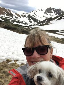 breast cancer survivor Cherry Creek. Mary White poses in the mountains with her dog, Buddy.