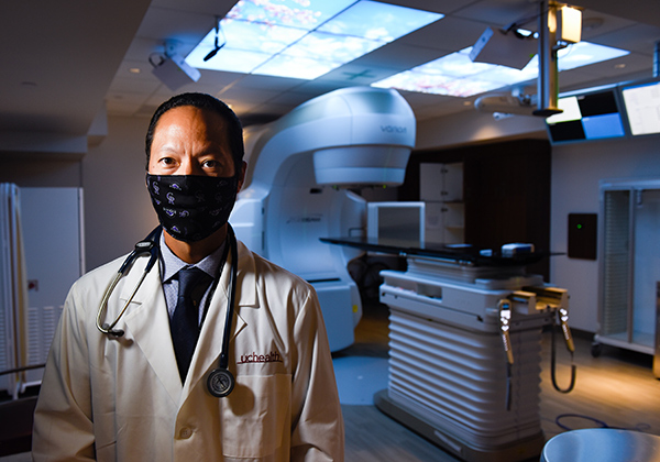 exceptional cancer care Cherry Creek. Dr. Scott Kono stands at the Cherry Creek Medical Center with a linear accelerator, It's a machine which delivers radiation treatments to cancer patients.