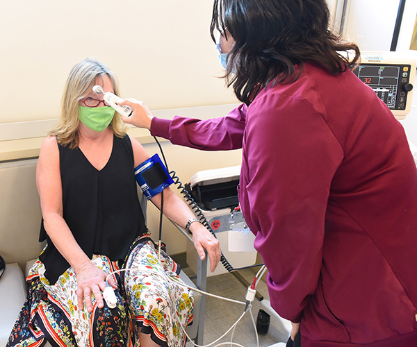 Mary White, breast cancer survivor, gets injections in Cherry Creek at the new UCHealth multi-specialty center
