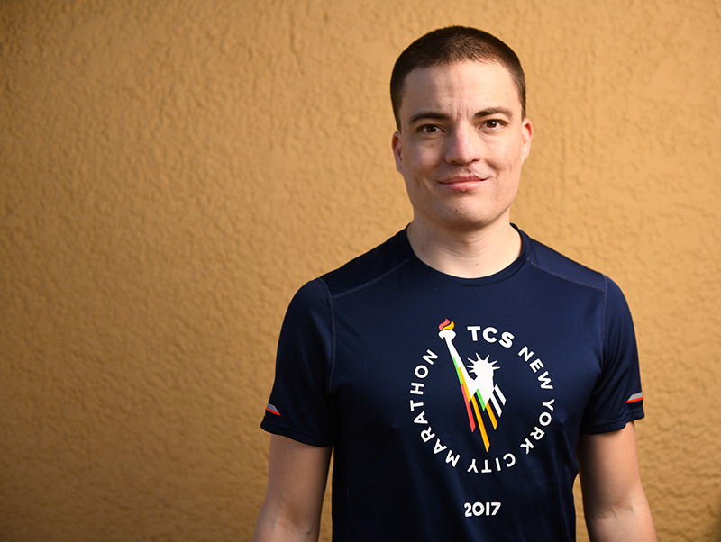 Matt Johnston was born with a heart defect and took up running to postpone surgery as long as possible. Here he poses in a shirt from one if his favorite races: the New York City Marathon.