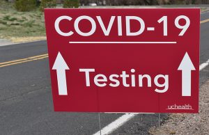 Sign points to COVID-19 testing site.