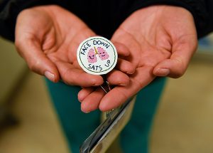 COVID=19 nurses. A nurse made a button that says "Face down. Sats up." Patients who lie on their bellies do better and have better oxygen saturations levels.