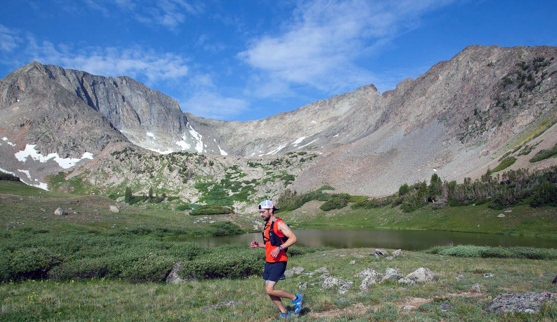 A man runs in the mountains.