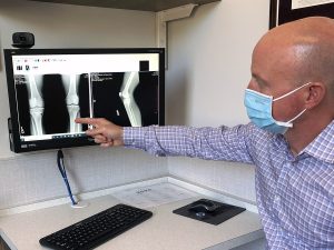 A physician explains a patient's x-rays.