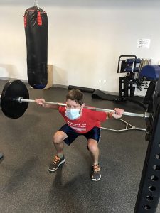 A man lifts weights.