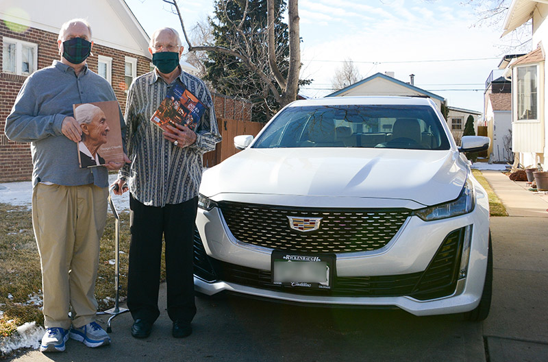 coronavirus vaccines for older adults - Jerry Flack, left, and George Summers, pose with their new car. They are excited to take a roadtrip to Santa Fe.