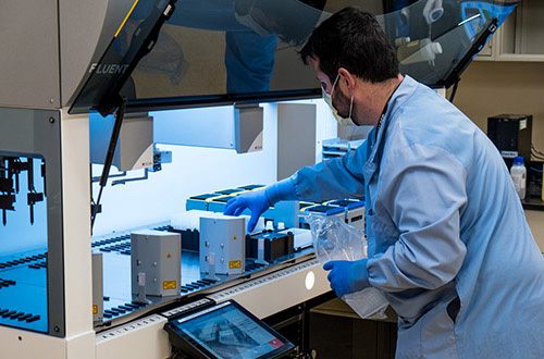 UCHealth clinical laboratory employee working with new COVID-19 testing technology