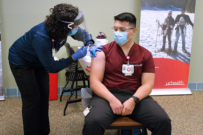 Nurse gets first dose of covid vaccine in December 2020. Will vaccine passports be required for air travel in the future?