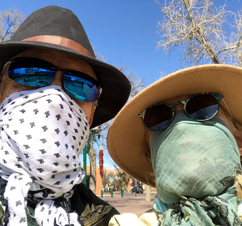 two people wearing bandanas as masks, which is not considered an optimal choice as there are better face mask options out there.
