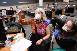 older adults are getting their coronavirus vaccines now. Joanna Moldow gives a thumbs up.