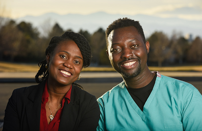 Drs. Cynthia and Kweku Hazel are eager to promote vaccine safety among Black people and other people of color. Here, they pose in a park with mountain views in the background.