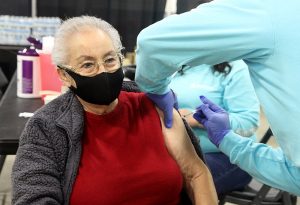 Marina Lopez, 85, part of the Hispanic community in Evans, Colorado, get's her COVID-19 vaccine during a vaccination clinic held by UCHealth and Aspen Community Health in Greeley.