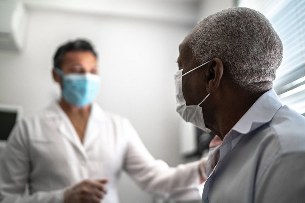 A doctor cares for a patient in a clinic. Understanding Medicare coverage for preventive health visits is essential.