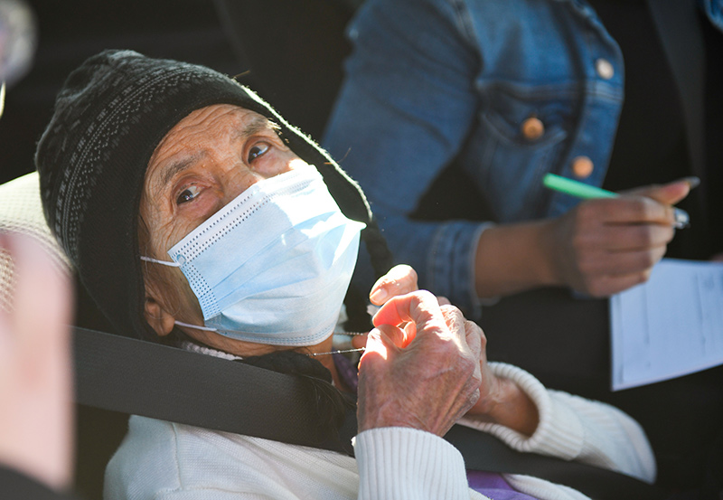 Soledad Balerrama shows her necklace that she uses like a rosary. Balderrama, 86, prayed about her decision to get a vaccine and now is praying for the pandemic to end.