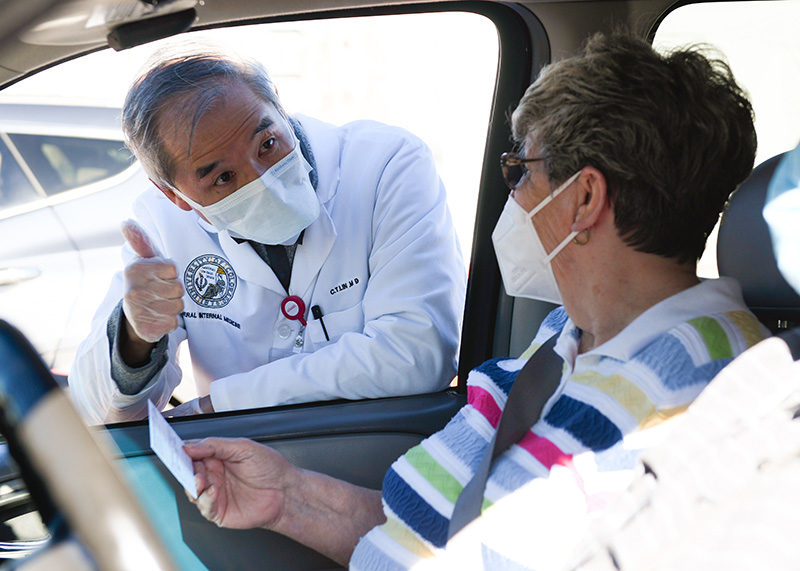 Dr. C.T. Lin inoculated people during a mass vaccination event at Coors Field.