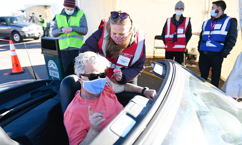 John Herrick, a retired lawyer and law professor, arrived for his vaccine in a convertible.