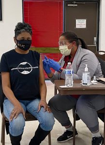 Dr. Nita Mosby Tyler, first lady of Shorter Community AME Church in Denver, gets her COVID-19 vaccine at church.