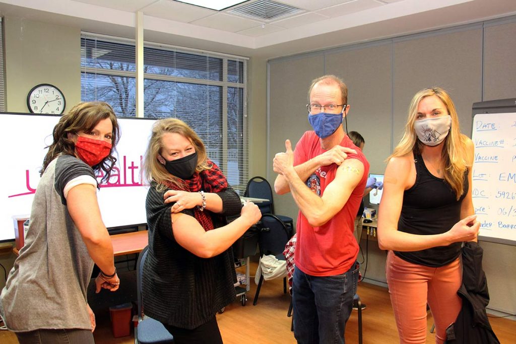 (from left to right) Lissa Chapman, second grade teacher at Soda Creek Elementary School; Amy Piva, eighth grade language arts and social studies teacher at Steamboat Springs Middle School; Charlie Leech, science teacher at Steamboat Springs High School; and Allie Sabat, physical education teacher at Strawberry Park Elementary School, receive their first doses of COVID-19 vaccine at UCHealth Yampa Valley Medical Center. Photo: Lindsey Reznicek.