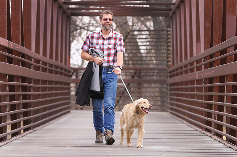 Wade L. Clements enjoys a walk with his dog Diesel. Because his employer partners with UCHealth for occupational health services, Wade's heart murmur was found before something serious happened to him.