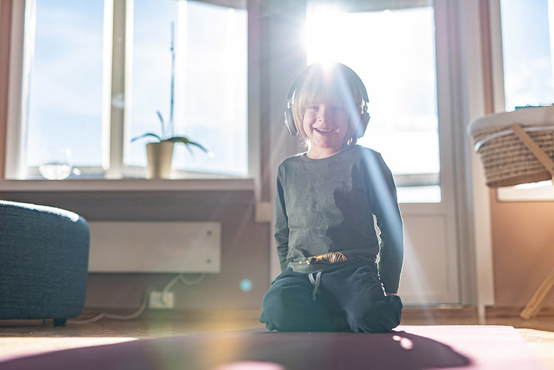Child with headphones getting the benefits of music before bed