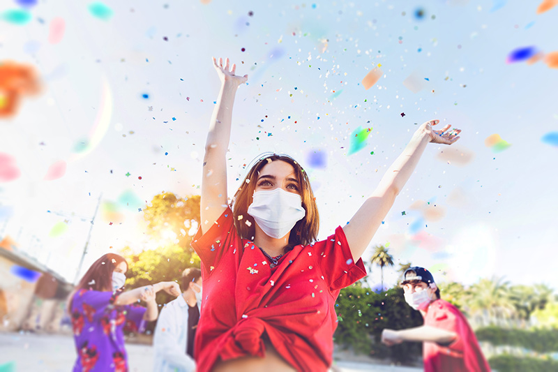 Woman celebrating outside as a way to restore human connection.