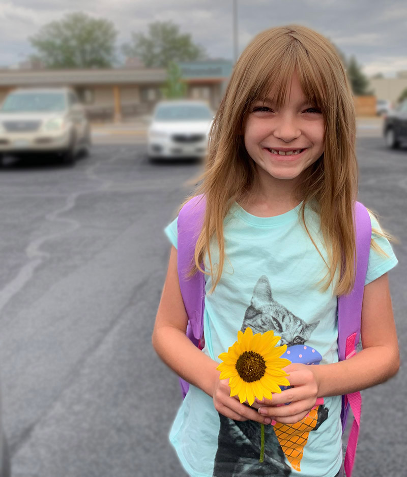 Juno, holding a sunflower.